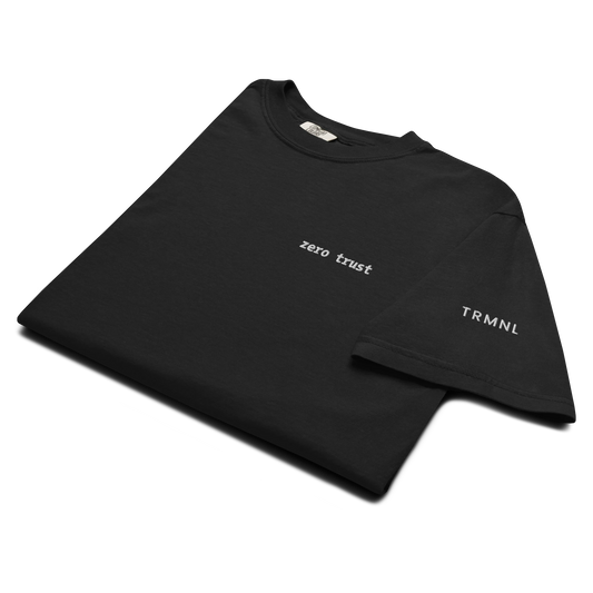 TRMNL black Supima cotton t-shirt featuring embroidered Zero Trust text on the chest and brand logo on the sleeve.